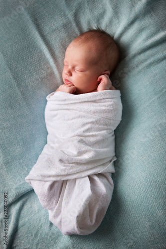 Newborn Baby Sleeping Peacefully, Wrapped in Blanket