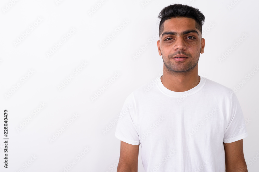 Young Indian man wearing white shirt against white background Young Indian man wearing white shirt against white background