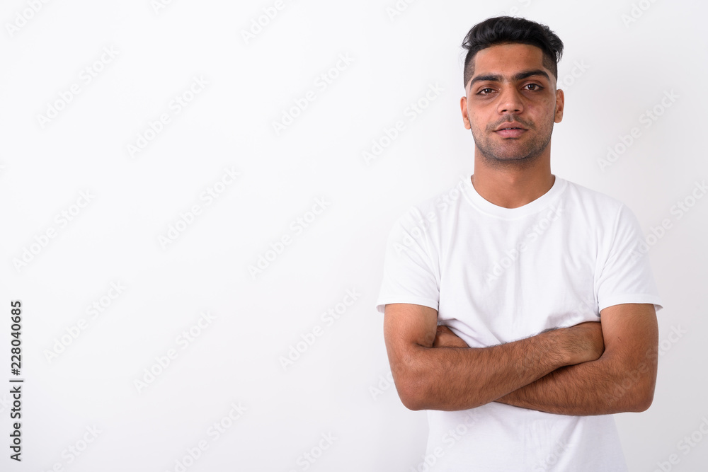 Young Indian man wearing white shirt against white background Young Indian man wearing white shirt against white background