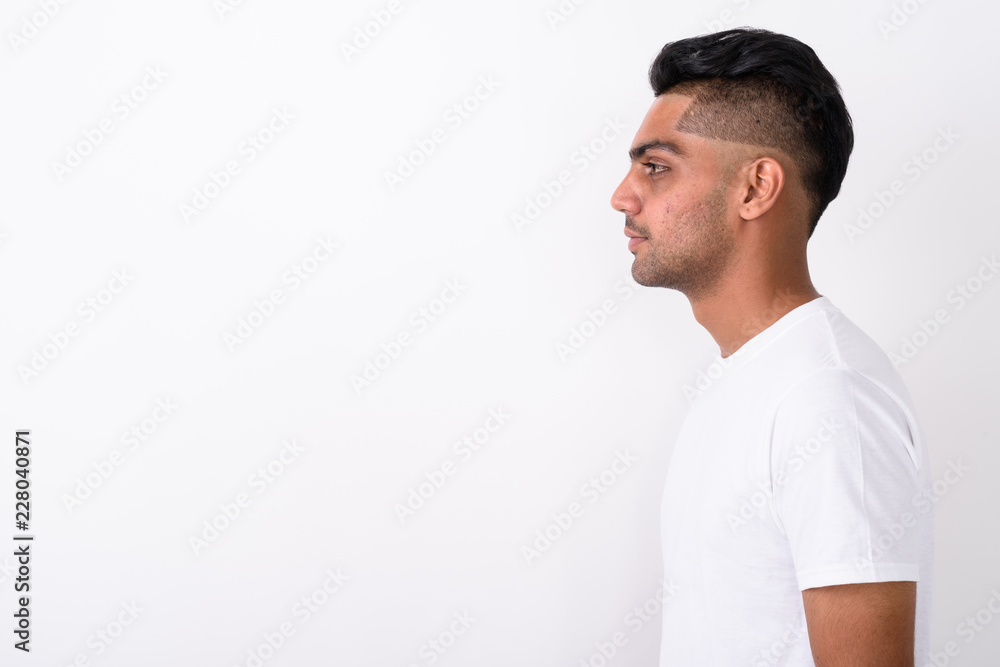 Young Indian man wearing white shirt against white background Young Indian man wearing white shirt against white background