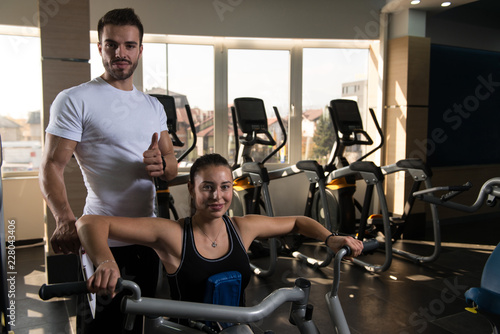 Woman Exercising Back With Her Personal Trainer