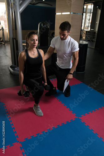 Young Couple Exercising With Kettle Bell