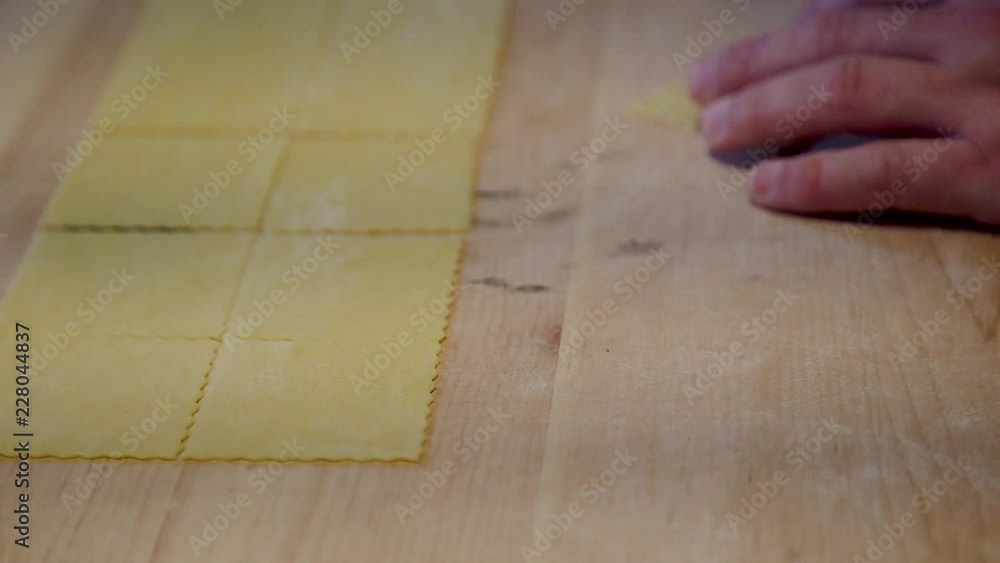 Chef preparing pasta sheets to be made into ravioli. Chef preparing pasta sheets to be made into ravioli.