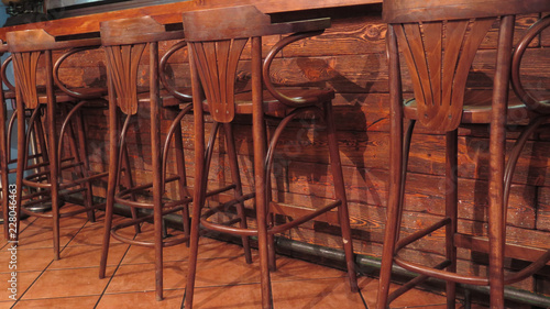 Row of vacant wooden bar stools