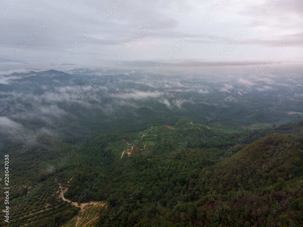 Aerial view of nature scenery. An aerial shot of hill with cloudy and misty background.