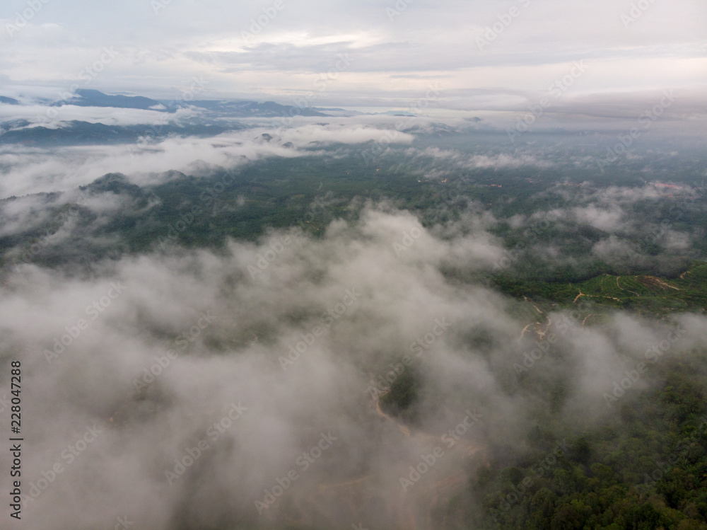 Aerial view of mountain with cloudy background.