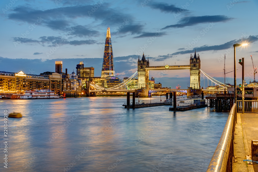 View of the river Thames in London after sunset with the Tower Bridge and the Shard in the back