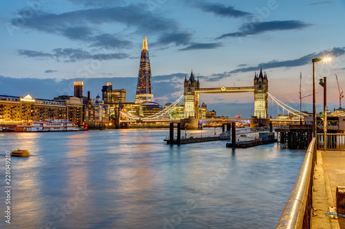 View of the river Thames in London after sunset with the Tower Bridge and the Shard in the back photo