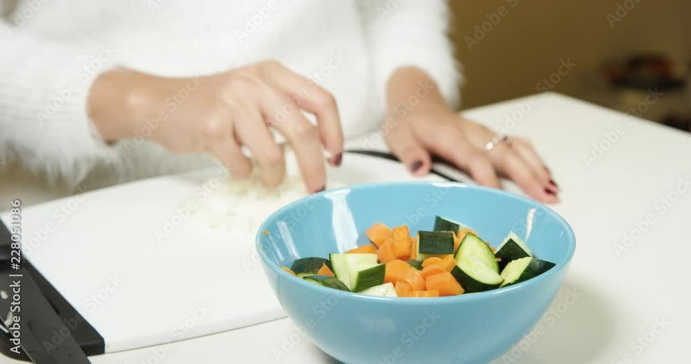 Putting chopped vegetables into a bowl for a salad Putting chopped vegetables into a bowl for a salad