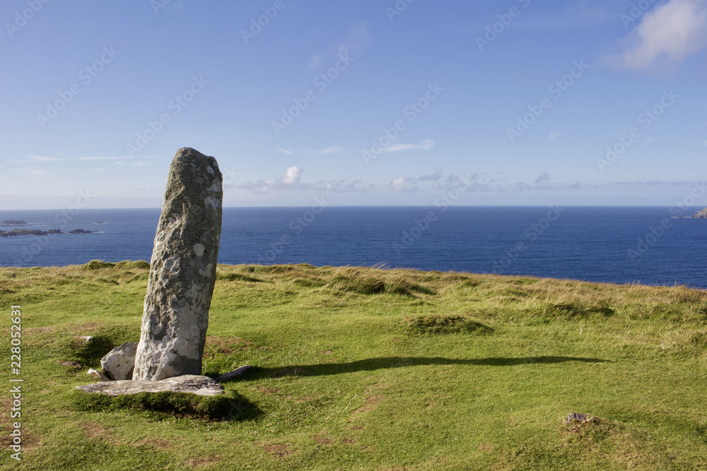 Close up view of an ancient ogham stone obelisk on the top of Dunmore Head on the Dingle Peninsula in County Kerry, Ireland
