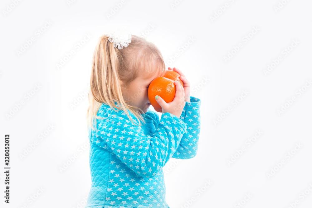 Child, little girl is posing posingly with tangerines. Child, little girl is posing posingly with tangerines.