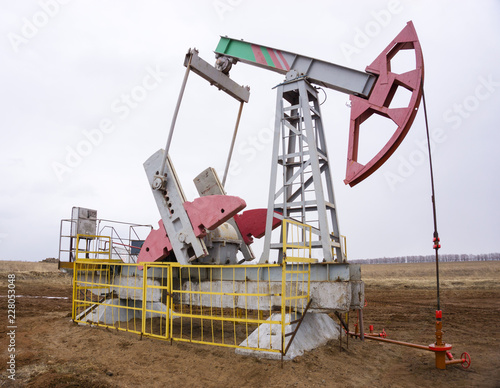 Oil pumps operate against a cloudy sky