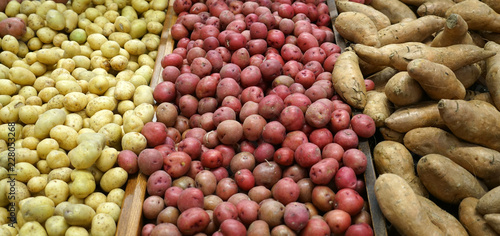 Fresh potatoes and sweet potato in the supermarket for sale