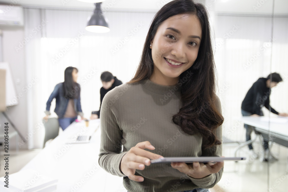 Asian women Students Smile and have fun and using tablet It also helps to share ideas in the work and project. Asian women Students Smile and have fun and using tablet It also helps to share ideas in the work and project.