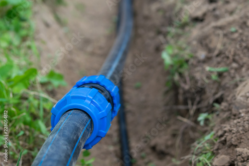 connection of water pipe close up against the background of the earth