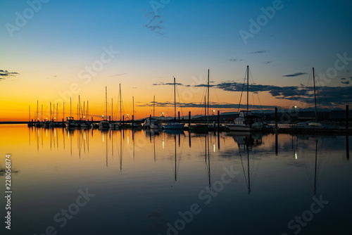 Fototapeta Naklejka Na Ścianę i Meble -  Beautiful sunset with sailboat in the crecent beach, Surrey, Canada