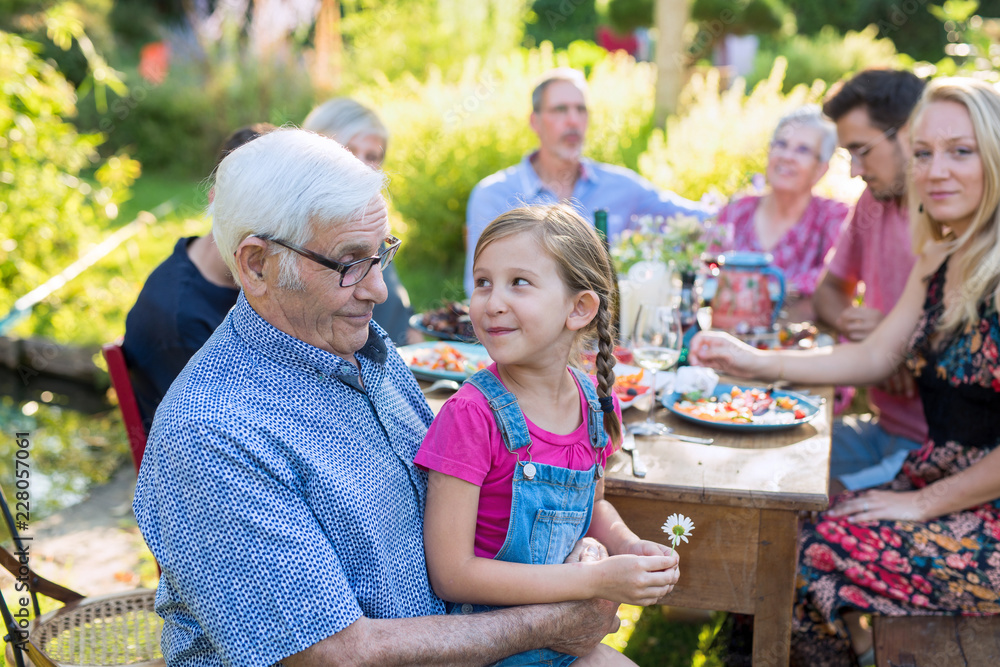 Family picnic closeup on a grandfather and his granddaughter Family picnic closeup on a grandfather and his granddaughter