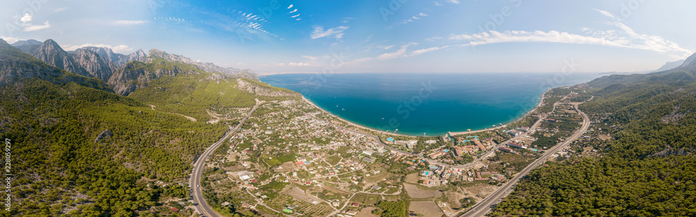 Panorama of the sea and mountain landscape with a serpentine road near the village of Kemer, Turkey. Aerial view