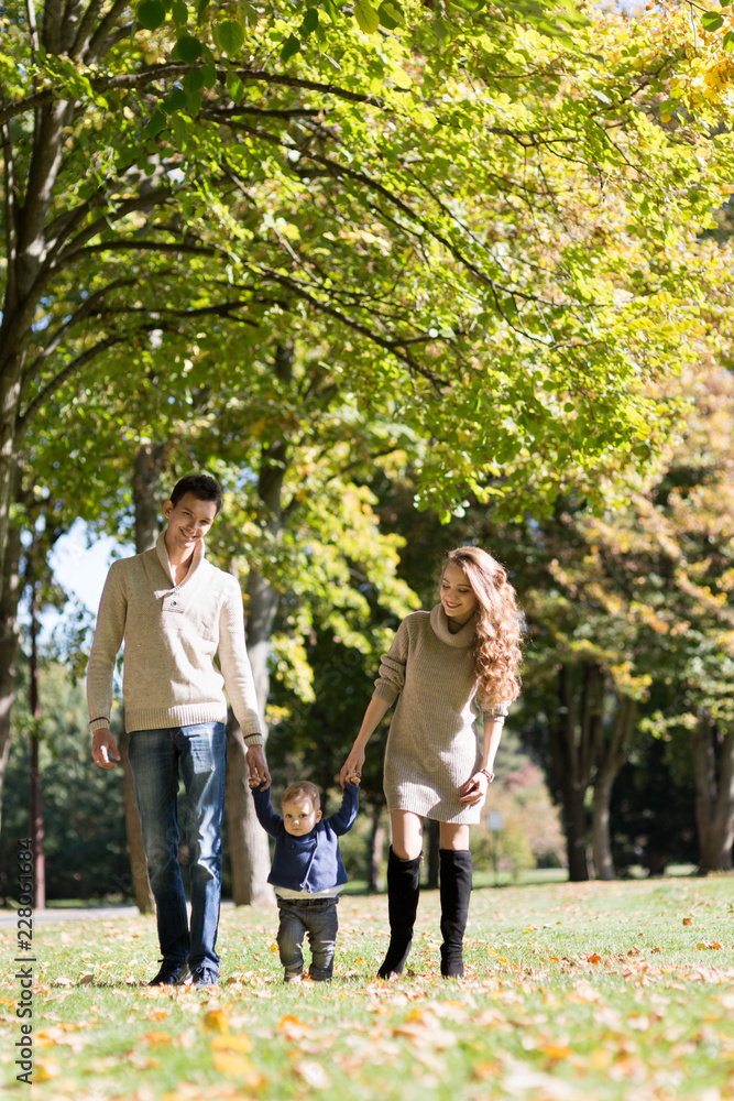 family with a baby in autumn park family with a baby in autumn park