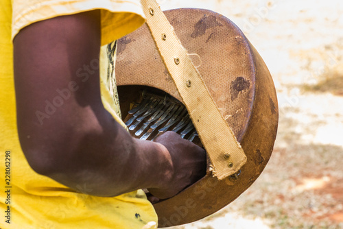 Man playing african musical instrument know as mbira