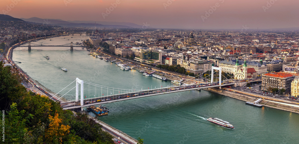 Budapest, Hungary - Aerial panoramic skyline of Budapest at sunset with Elisabeth Bridge (Erzsebet Hid), Szechenyi Chain Bridge, Parliament and sightseeing boat on River Danube