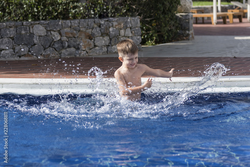little boy plaiyng in swimming pool © Alexey Sizov