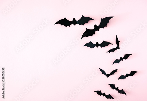 Halloween decorations concept. Halloween bats on pastel pink background. Flat lay, top view, copy space 