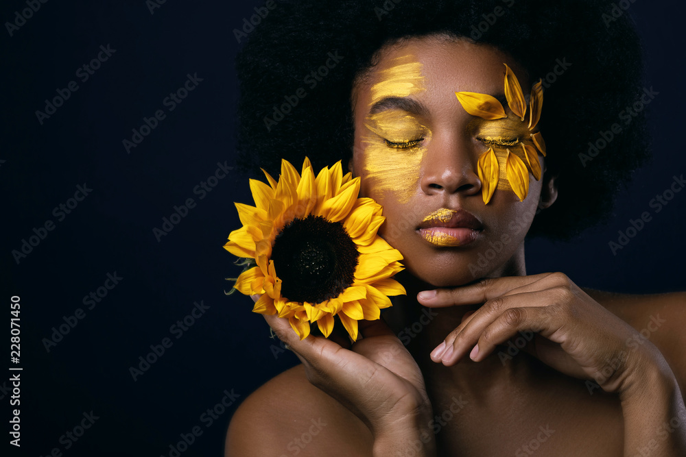 African woman with a sunflower and creative makeup on her face Stock Photo  | Adobe Stock