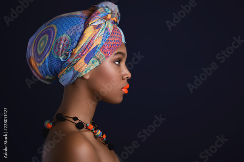 African woman with a colorful shawl on her head photo