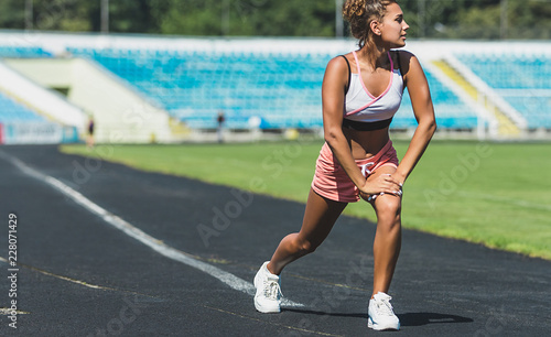 Fitness woman doing lunges exercises for leg muscle workout training, outdoors. Active girl doing front forward one leg step lunge exercise