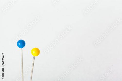 Colorful pushpins on a white board. School or business concept © NewFabrika