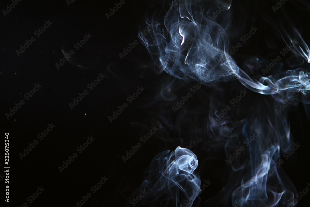 marvellous swirl glowing bright smoke on the heavy black background.