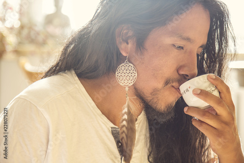 Portrait of young latino man drinking tea photo