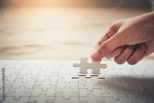 Female Hand is Putting Last Piece Jigsaw Puzzle to Complete Mission, Close-Up of Woman Hand Fulfillment Last Piece of Jigsaw Puzzle to Matching Complete. Business Solutions, Success Missions Concept.