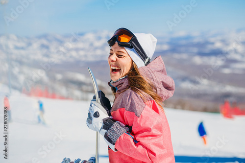 cheerful woman snowboarder laughs