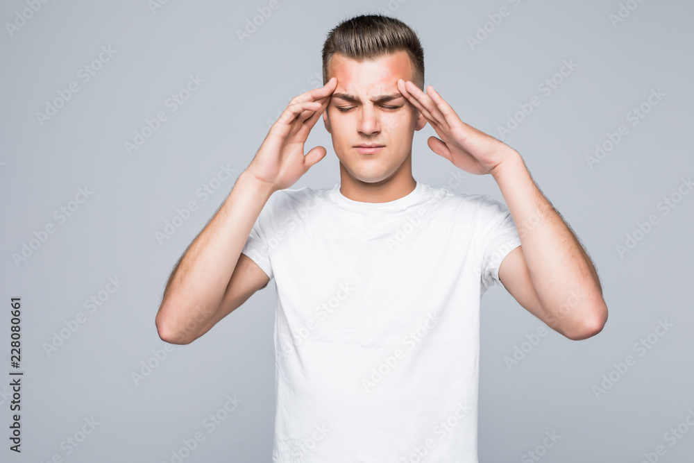 Young handsome minded man trying to find way to solve problem isolated on gray background Young handsome minded man trying to find way to solve problem isolated on gray background