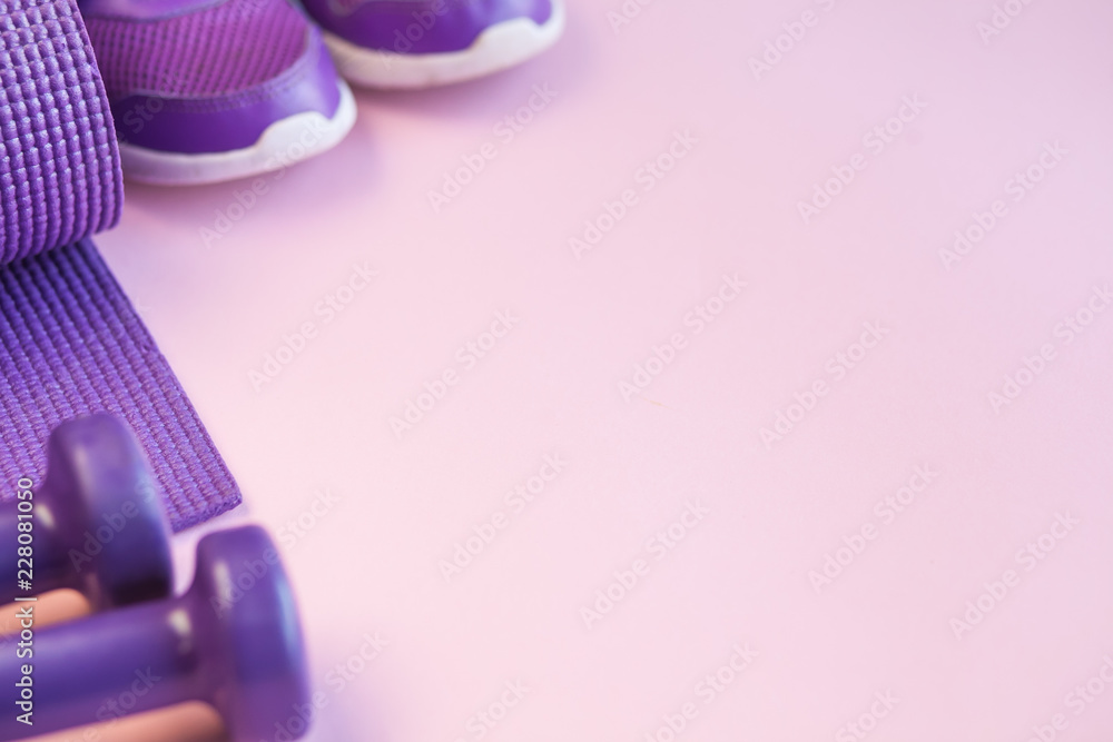 Obraz premium Sports background with copy space. Top view dumbbells, mat, and sneakers. Fitness concept. 