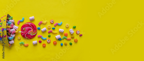 Candy caramel on a yellow background. Celebration.