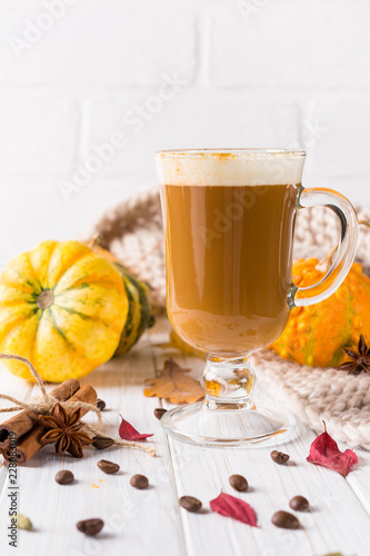 Traditional autumn dishes. Halloween, Thanksgiving. Mug of  hot and spicy aromatic pumpkin latte with whipped cream on top. Ingredients for cook spicy pumpkin latte on white background