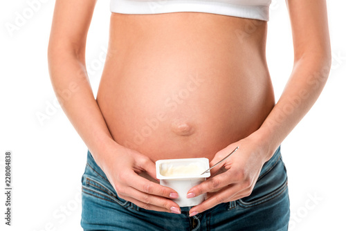 cropped view of pregnant woman holding yogurt isolated on white