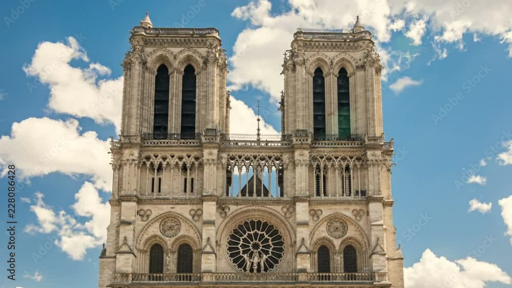 Famous Notre-Dame Cathedral front facade, Paris, France. White clouds move acroos the blue sky, time lapse video. Famous Notre-Dame Cathedral front facade, Paris, France. White clouds move acroos the blue sky, time lapse video.