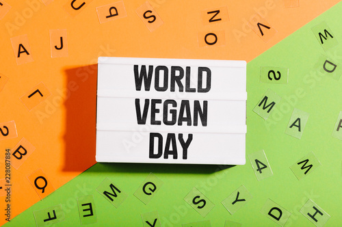 World Vegan Day words in light box on bright flat lay background