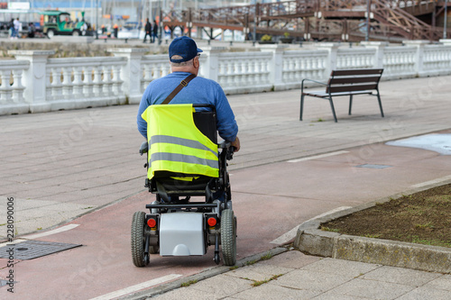 disabled person in an electric wheelchair on the street