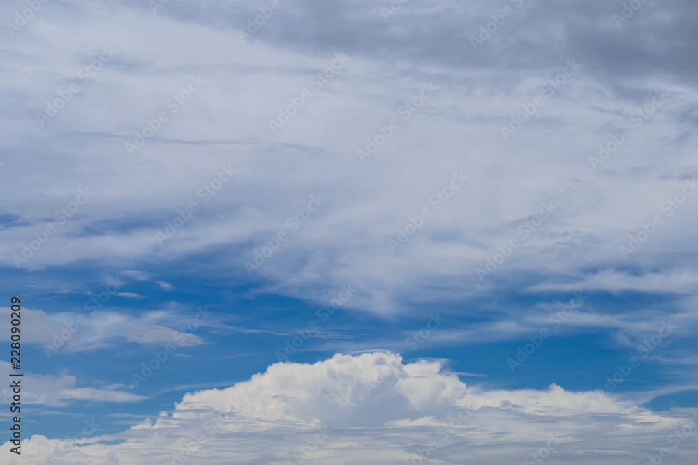 Rain clouds forming with blue sky background