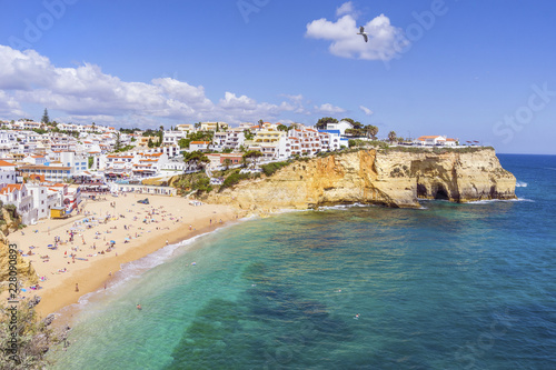 Beautiful Carvoeiro with colorful houses by wide sandy beach