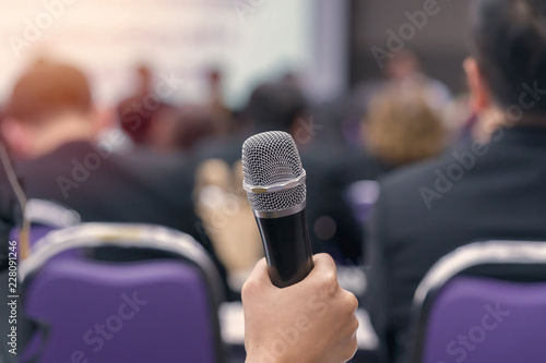 hand hold Microphone in meeting room for a conference © CasanoWa Stutio