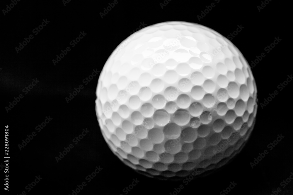 Close Up of Golf Ball, Isolated on Black Background Close Up of Golf Ball, Isolated on Black Background