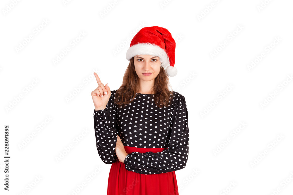 confused woman pointing finger up. emotional girl in santa claus christmas hat isolated on white background. holiday concept confused woman pointing finger up. emotional girl in santa claus christmas hat isolated on white background. holiday concept