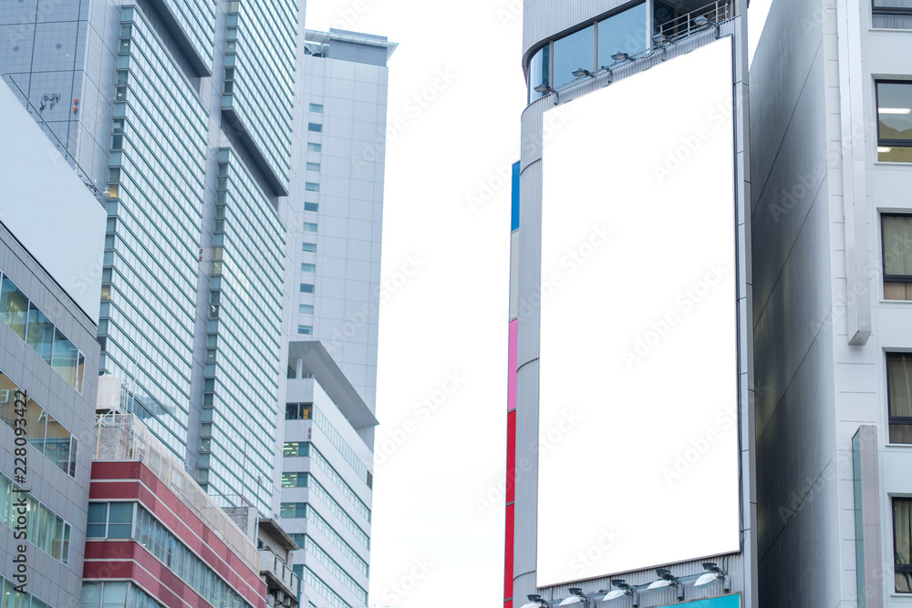 Naklejka premium Blank billboard or advertising poster on the building wall mock up, for advertisement concept background
