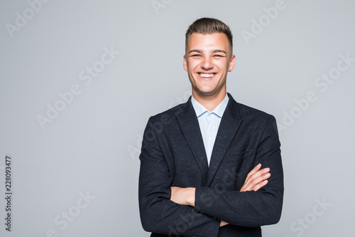 Fényképezés Portrait of businessman with crossed hands, isolated on white background